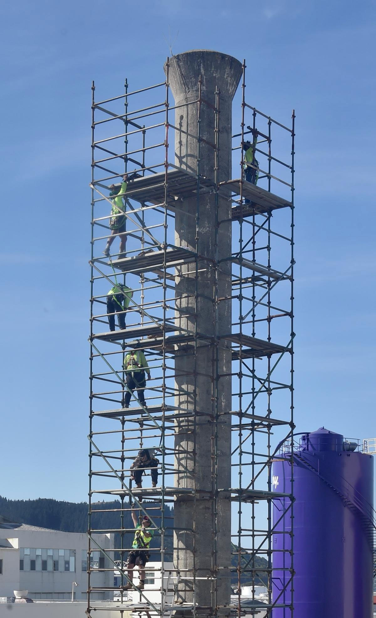 Industrial scaffold tower around a tall concrete chimney